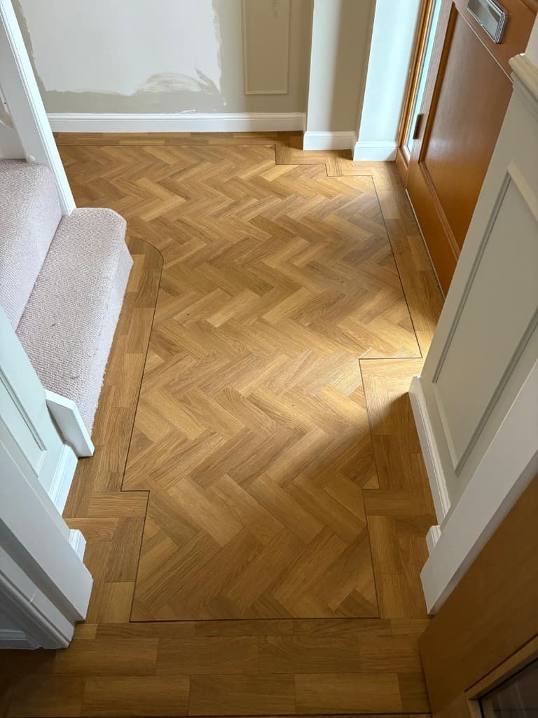 Herringbone LVT flooring installation with custom border — Parfait Flooring, Glasgow